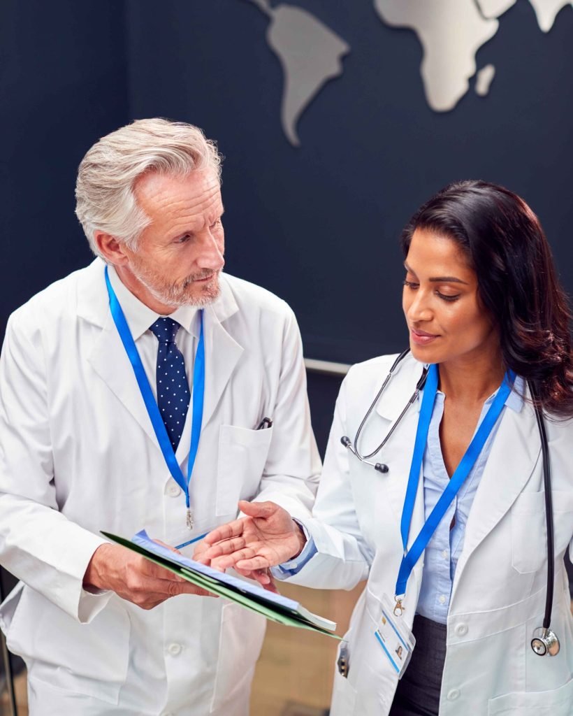 two-medical-staff-wearing-white-coats-discussing-p-2024-10-21-05-07-58-utc_11zon